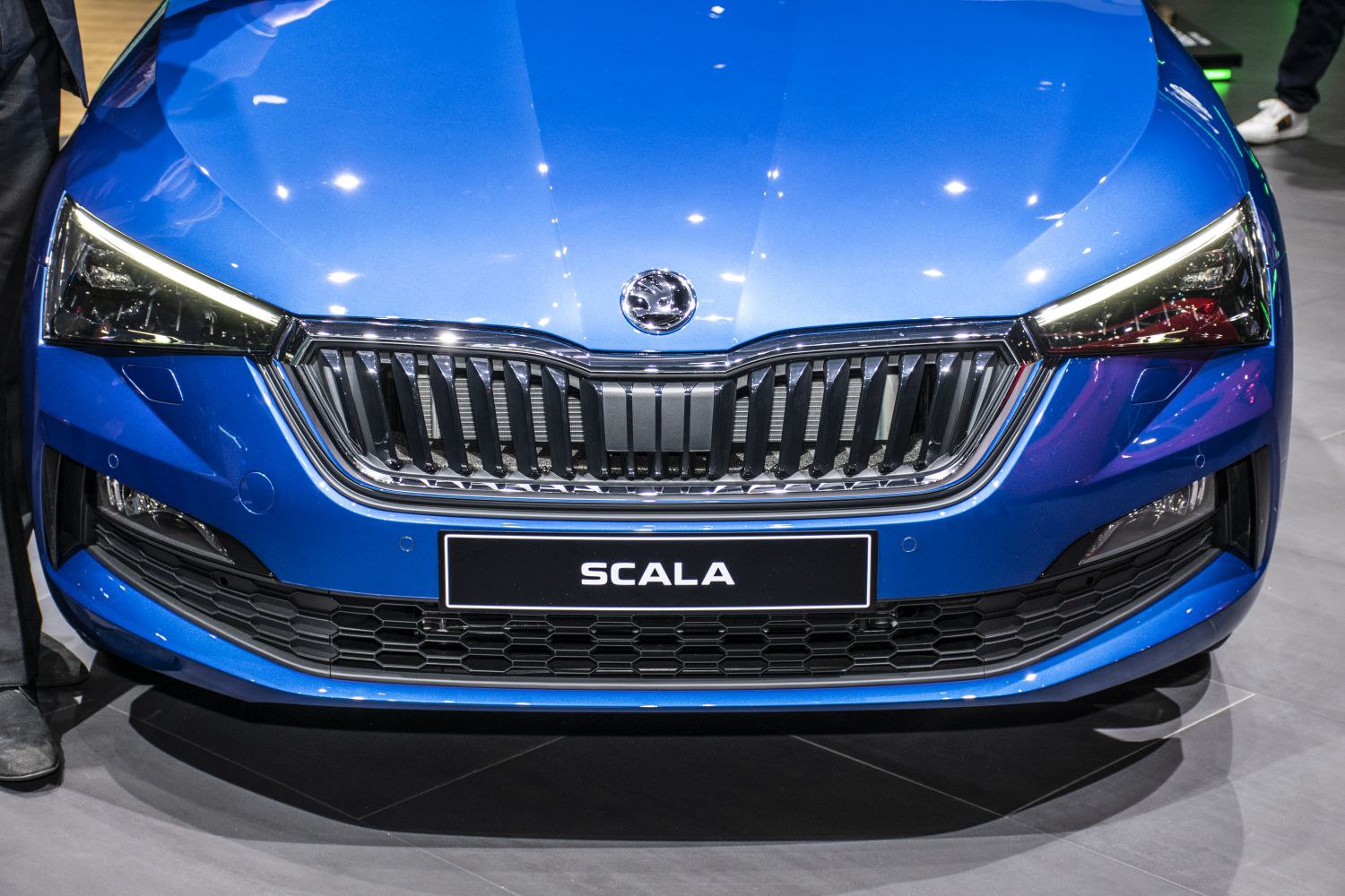 Close-up of front grille and LED headlights with chrome accents