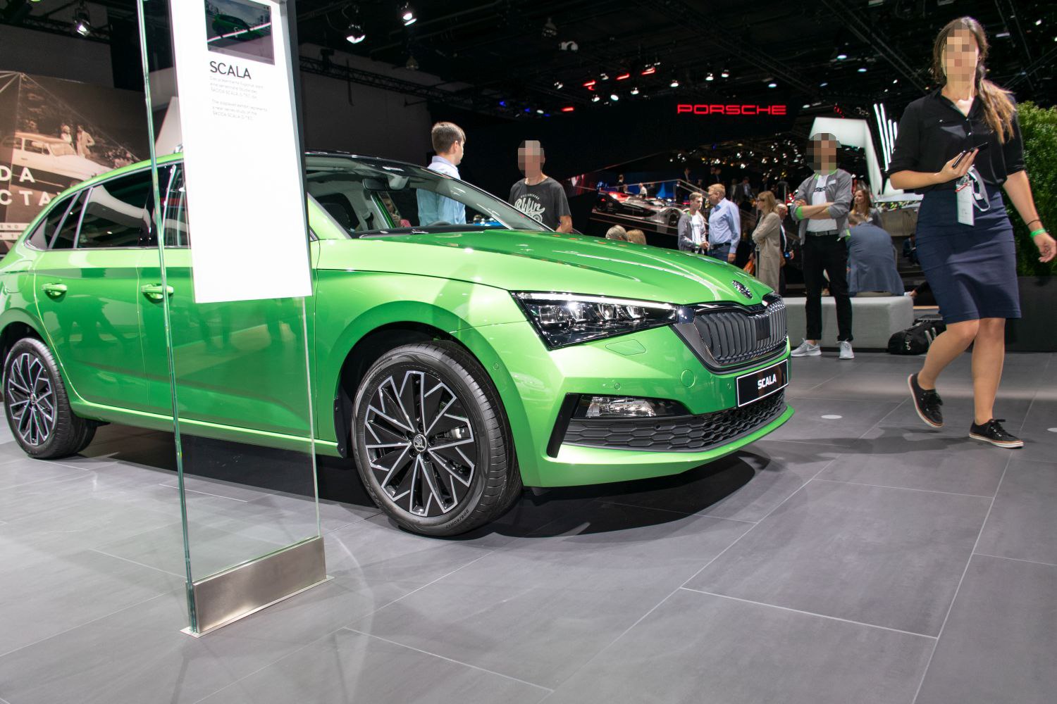 Front fascia and alloy wheels of a vibrant green hatchback