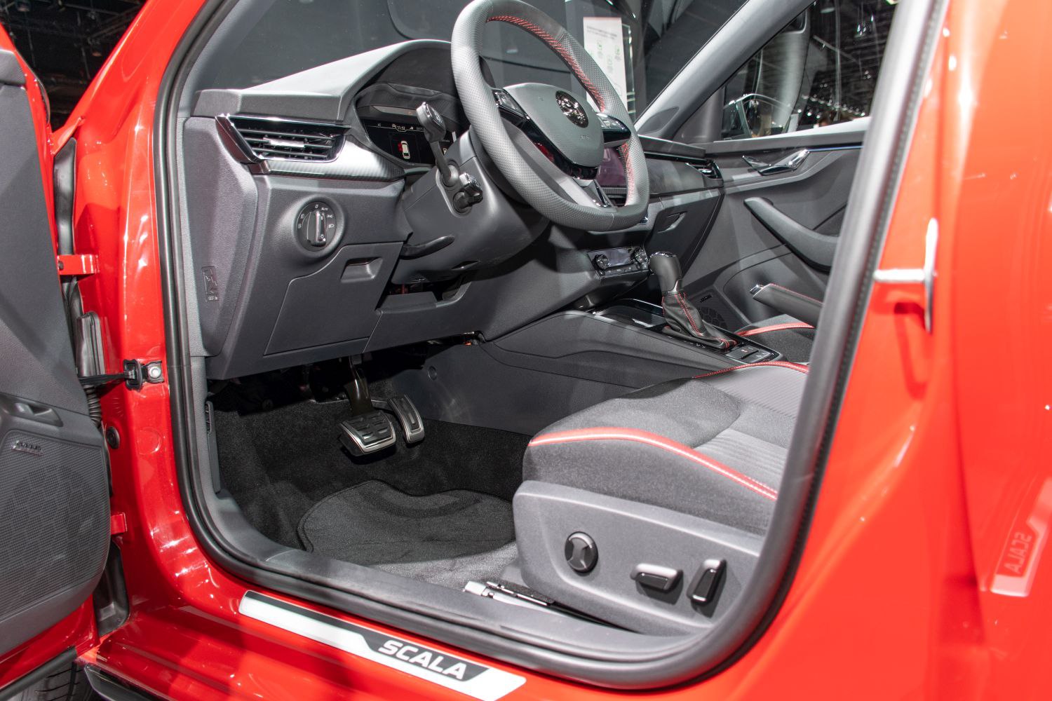 Sporty interior with red-accented seats and modern dashboard