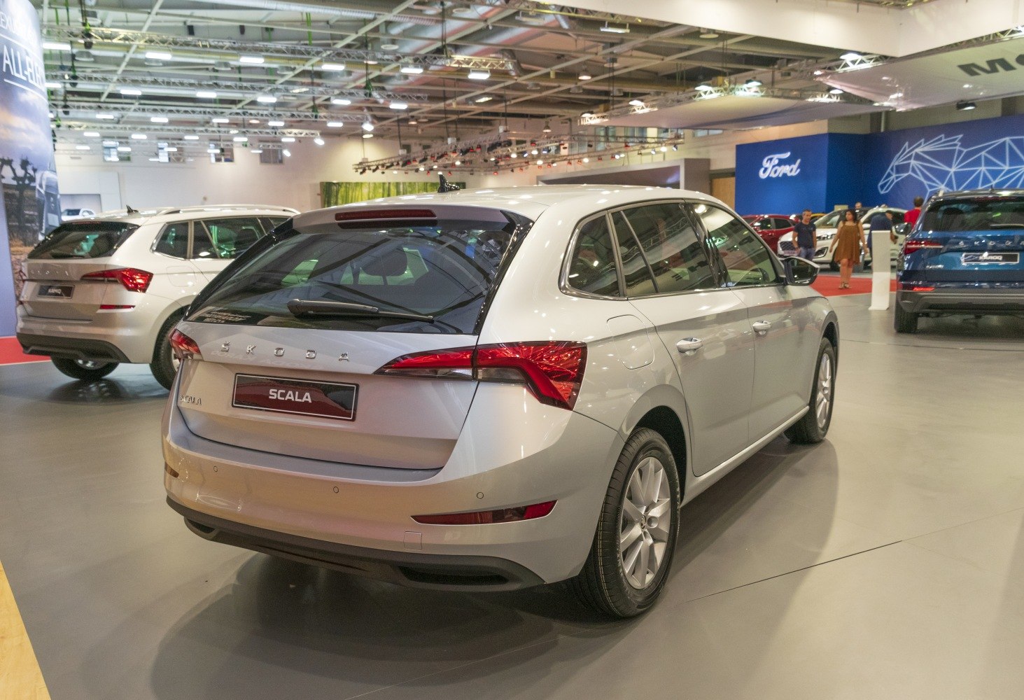 Rear side view of silver hatchback with taillights and rear windshield wiper