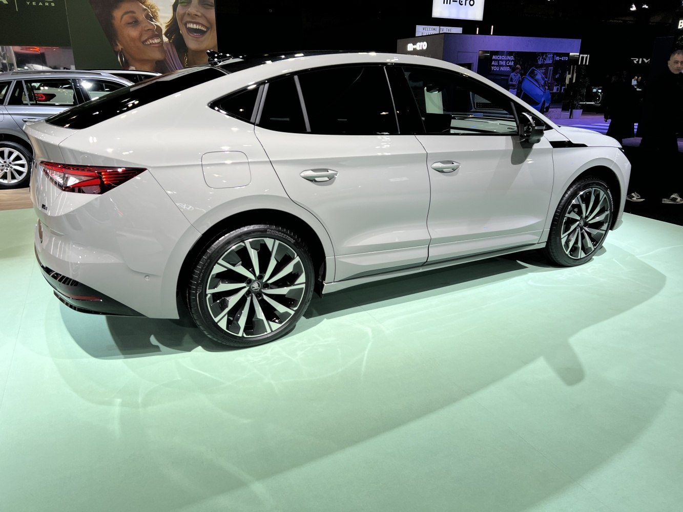 Rear-side view of sleek electric coupe with tinted windows and alloy wheels