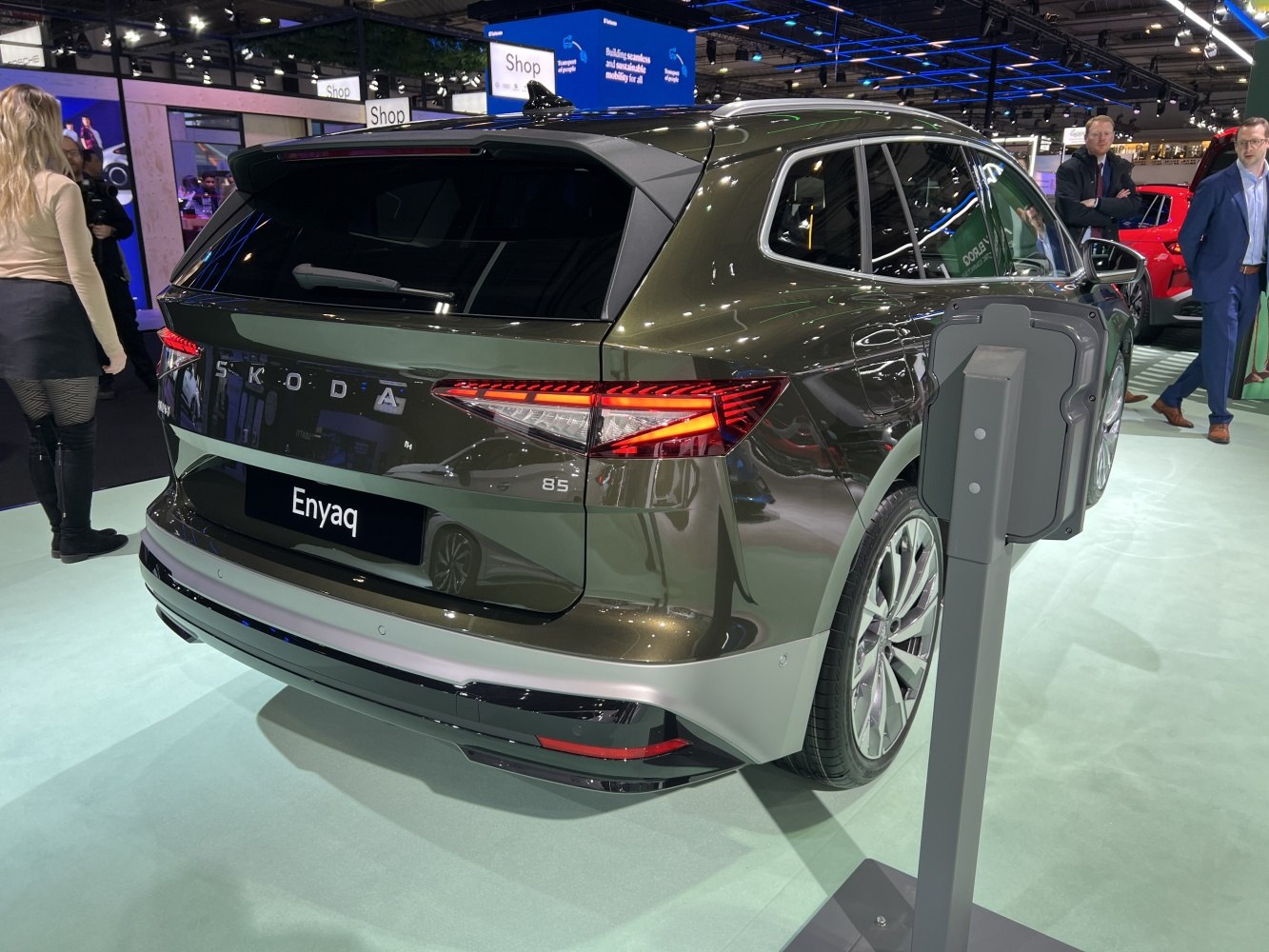 Rear view of electric SUV with LED taillights and charging station