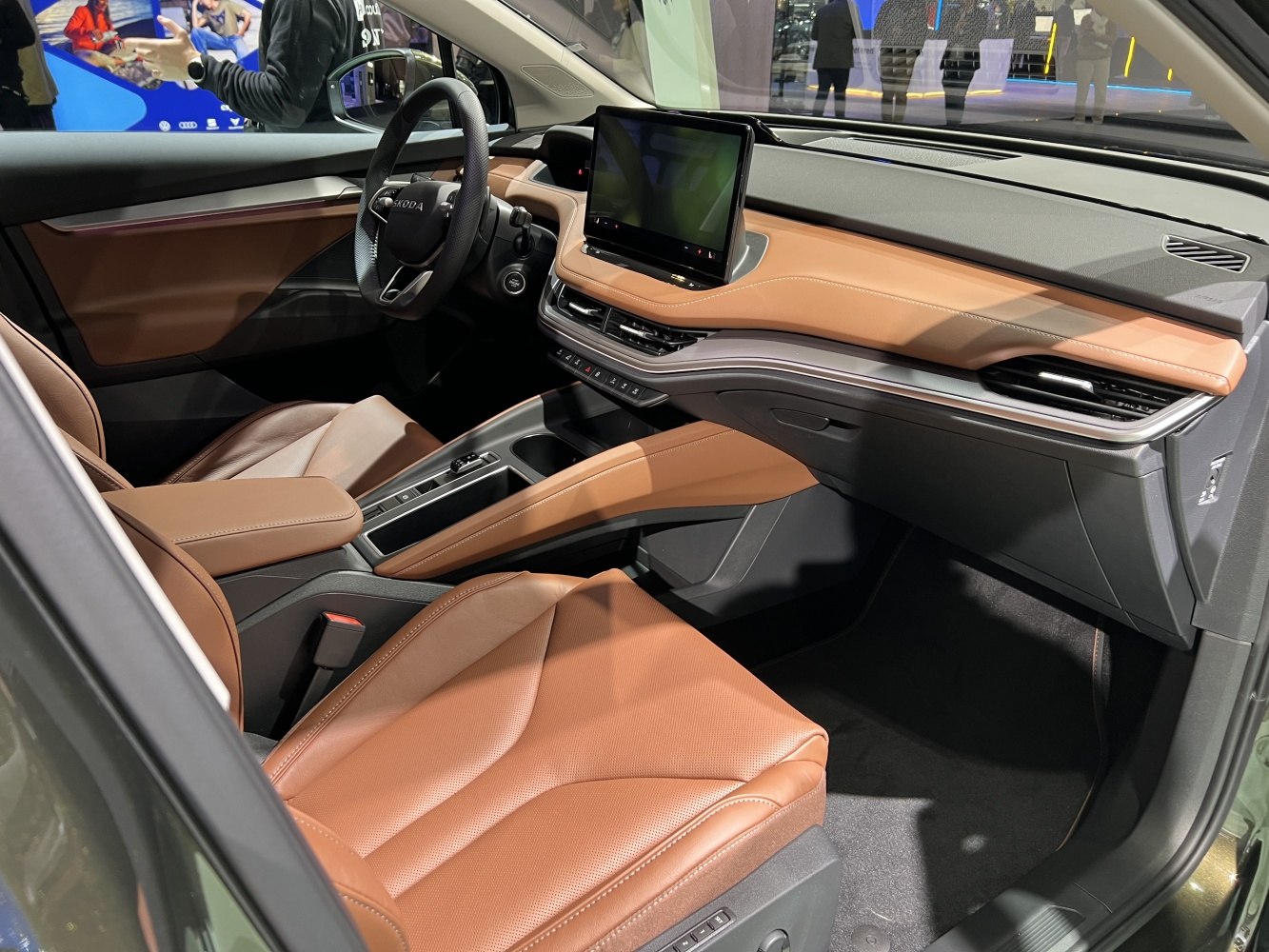 Modern car interior with touchscreen dashboard and brown leather seats