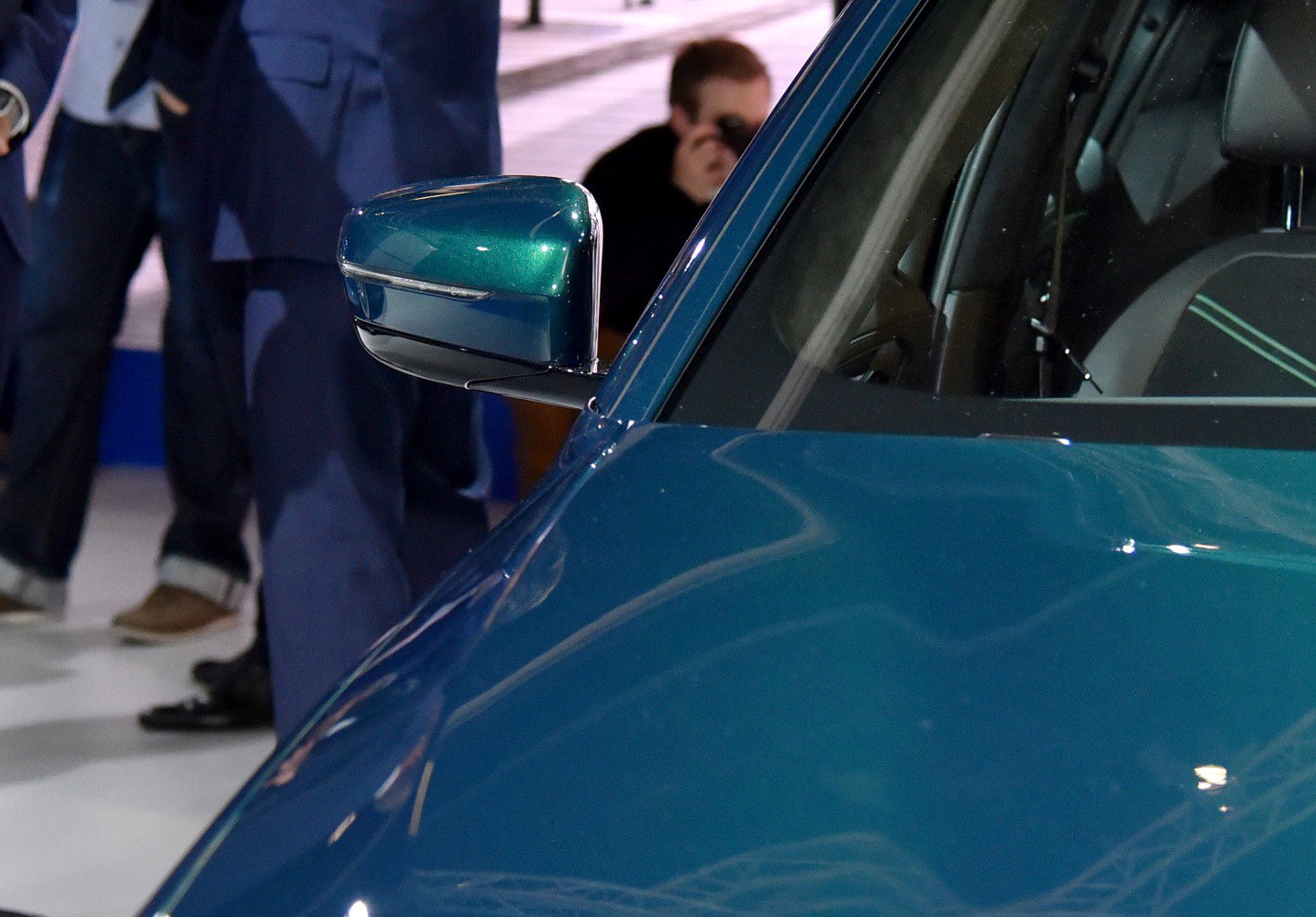 Side mirror and front door window with blue car paint