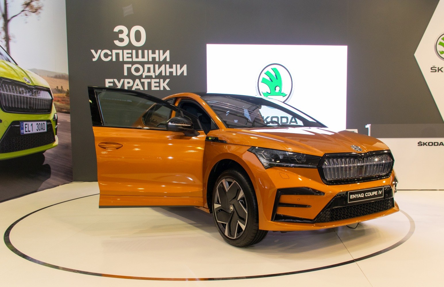 Front-angle view with open door, distinctive grille and futuristic headlights