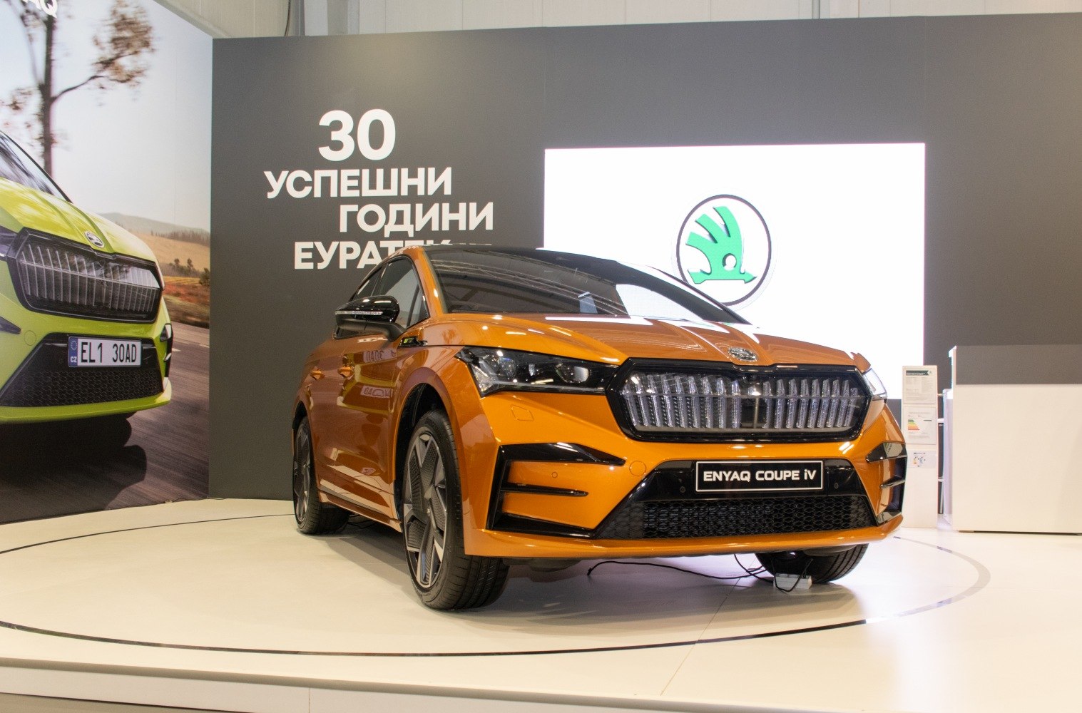 Bold front grille and sleek LED headlights of an orange SUV