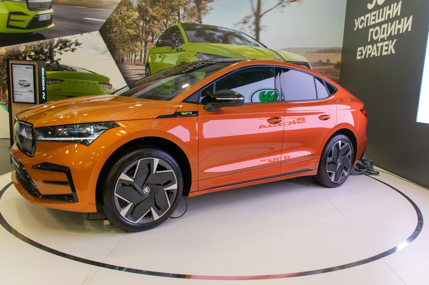 Orange coupe SUV side profile with modern multi-spoke wheels