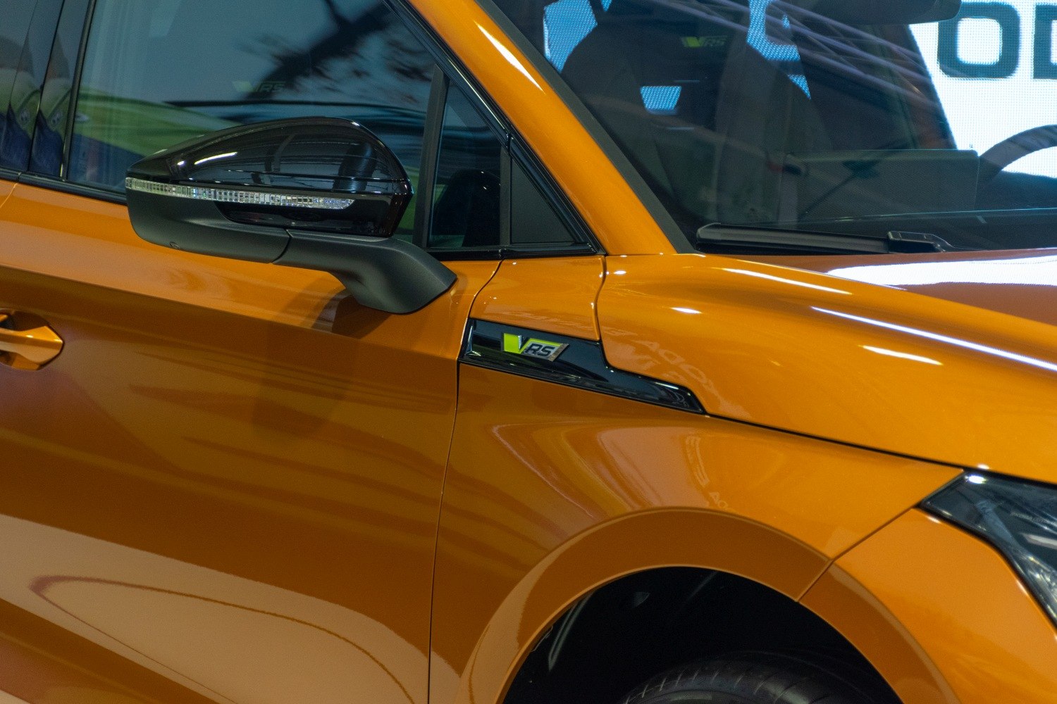 Side mirror and VRS badge on orange vehicle door