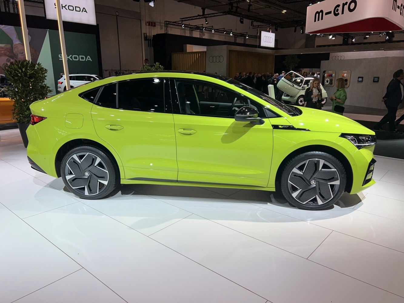 Side profile of a modern electric sedan with aerodynamic alloy wheels and coupe design.