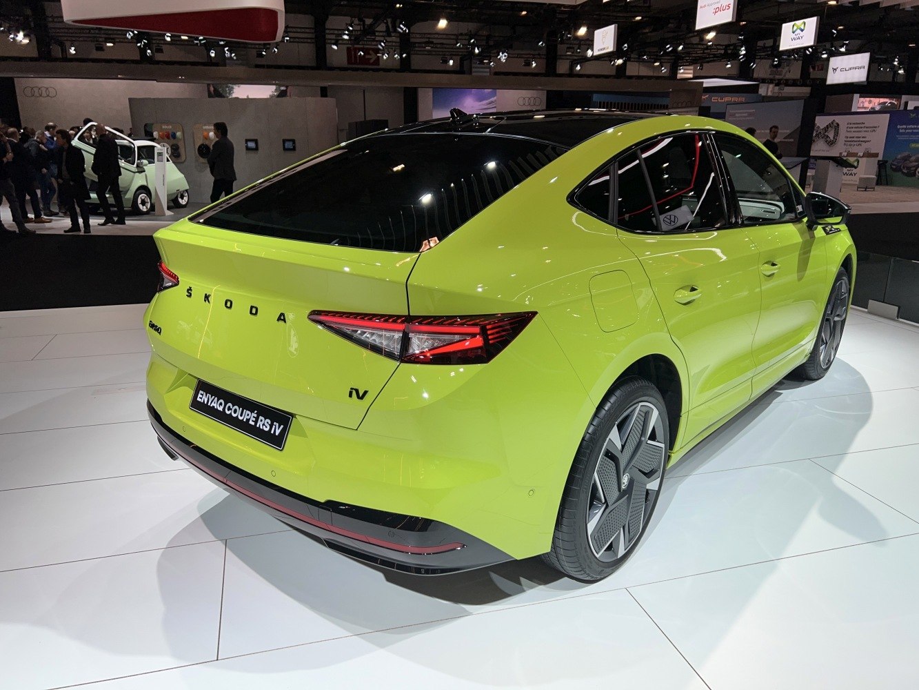 Rear side view of lime green EV with sharp taillights and futuristic wheels