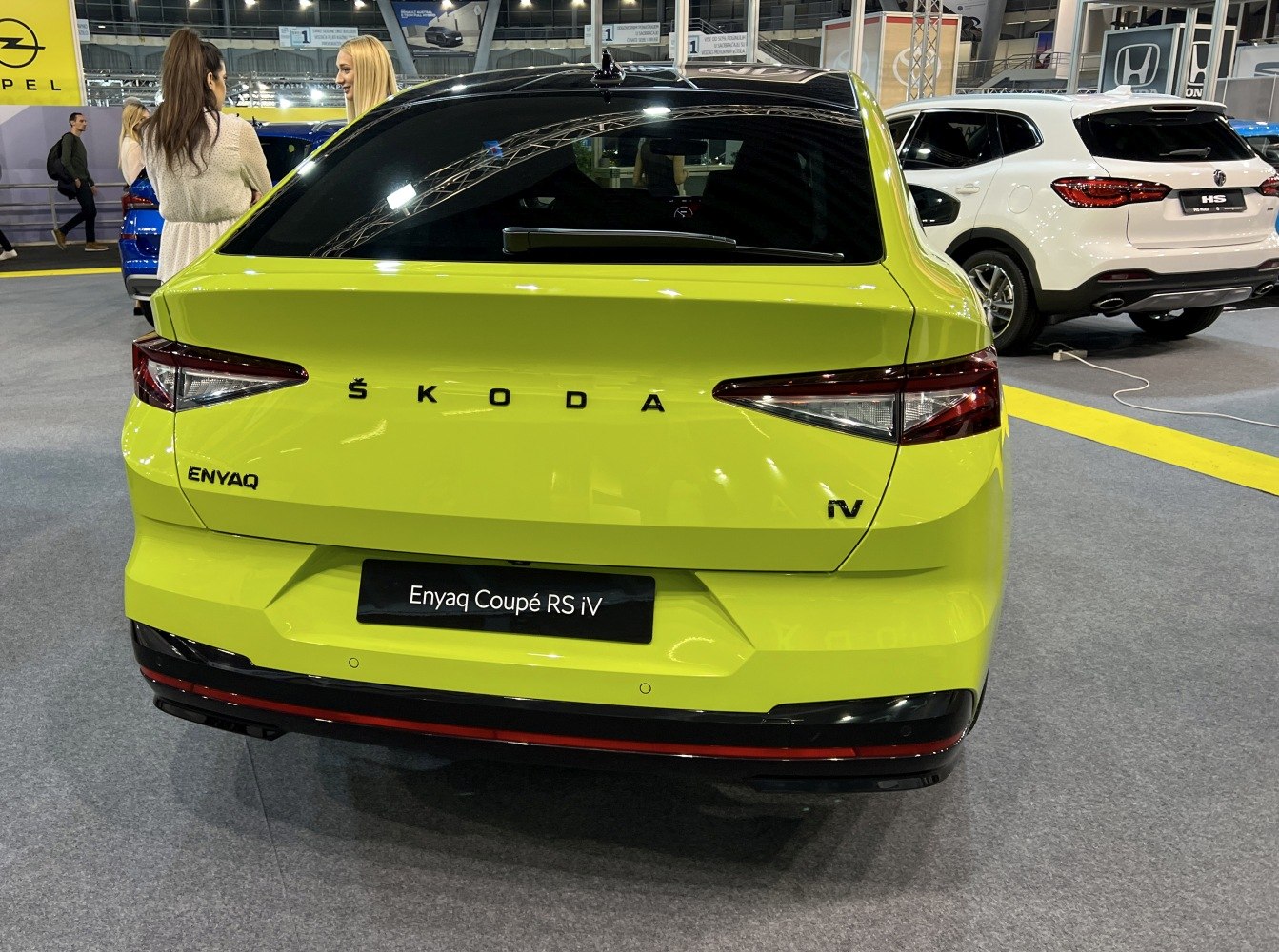 Rear view of bright green electric SUV with sleek tail lights.