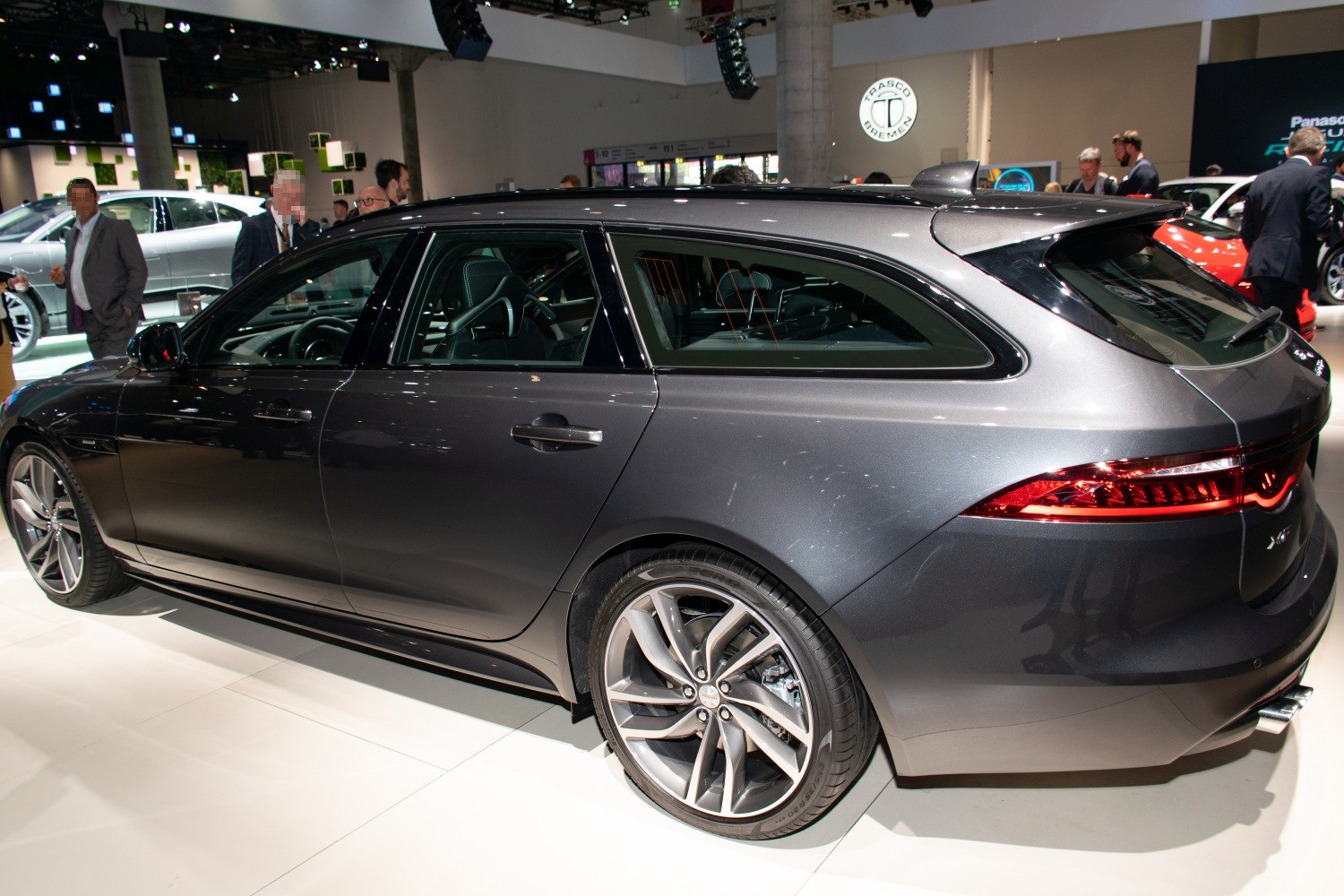 Sleek wagon side and rear view with distinctive alloy wheels and taillight design