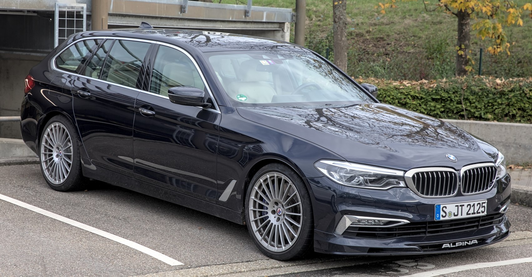 Sleek luxury wagon with distinctive Alpina multi-spoke alloy wheels and chrome-accented front grille