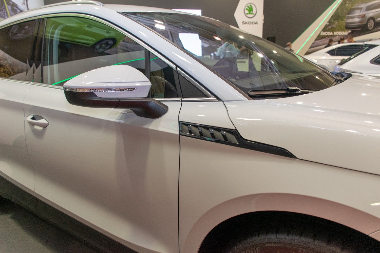 Side mirror and door panel with trim accents on a modern SUV