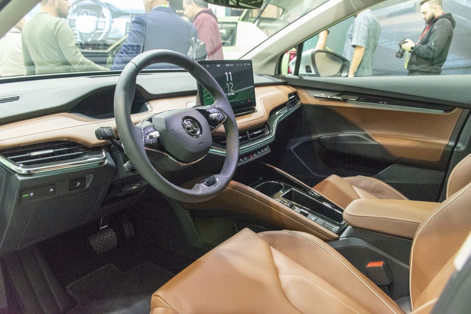 Modern car interior with digital dashboard and brown leather seats