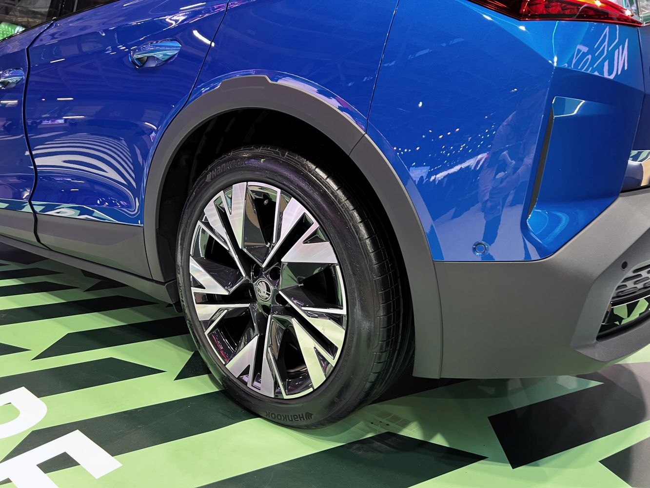 Alloy wheel and rear fender area in blue car body