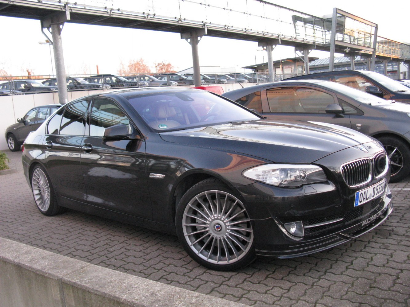 Black sedan with Alpina multi-spoke wheels and aerodynamic front lip