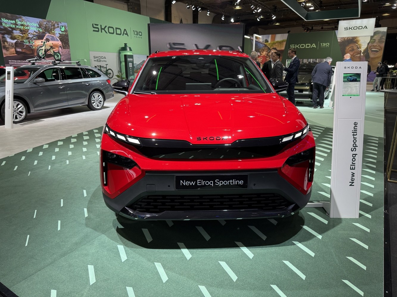 Front view of a red SUV with sleek LED headlights and bold black grille.