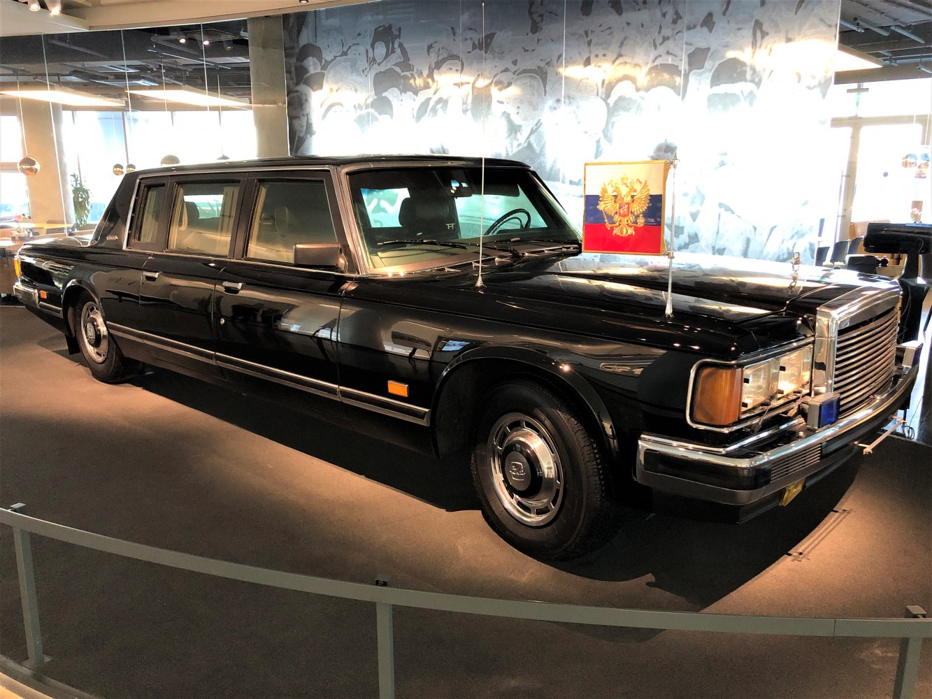 Black luxury long wheelbase limousine with classic front grille and flag