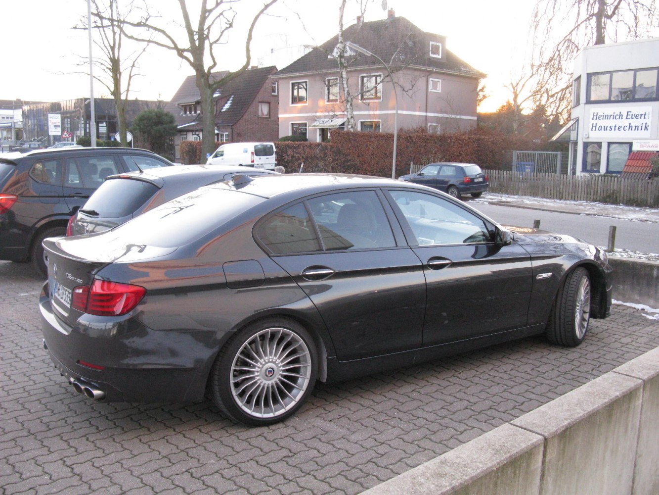 Rear side view showing multi-spoke wheels and quad exhausts