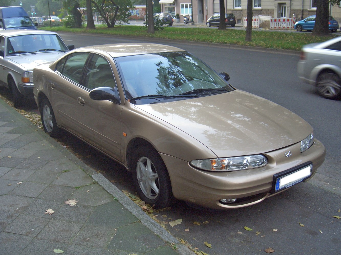 Front-side view of a mid-size sedan with oval headlights and smooth body.