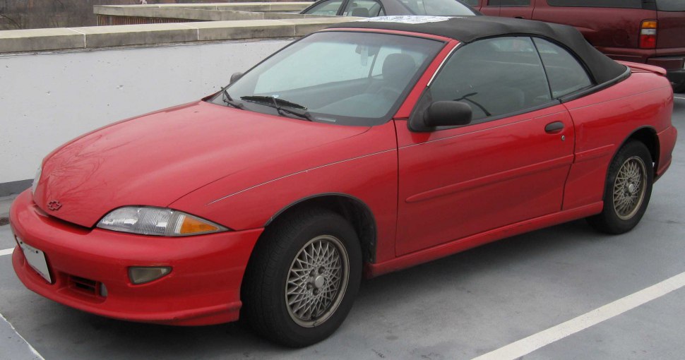 Red convertible with black soft-top and sporty mesh wheels
