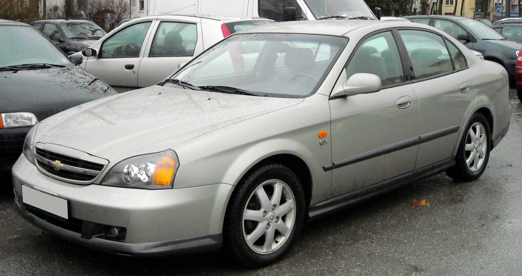 Silver sedan with alloy wheels and classic front headlights.