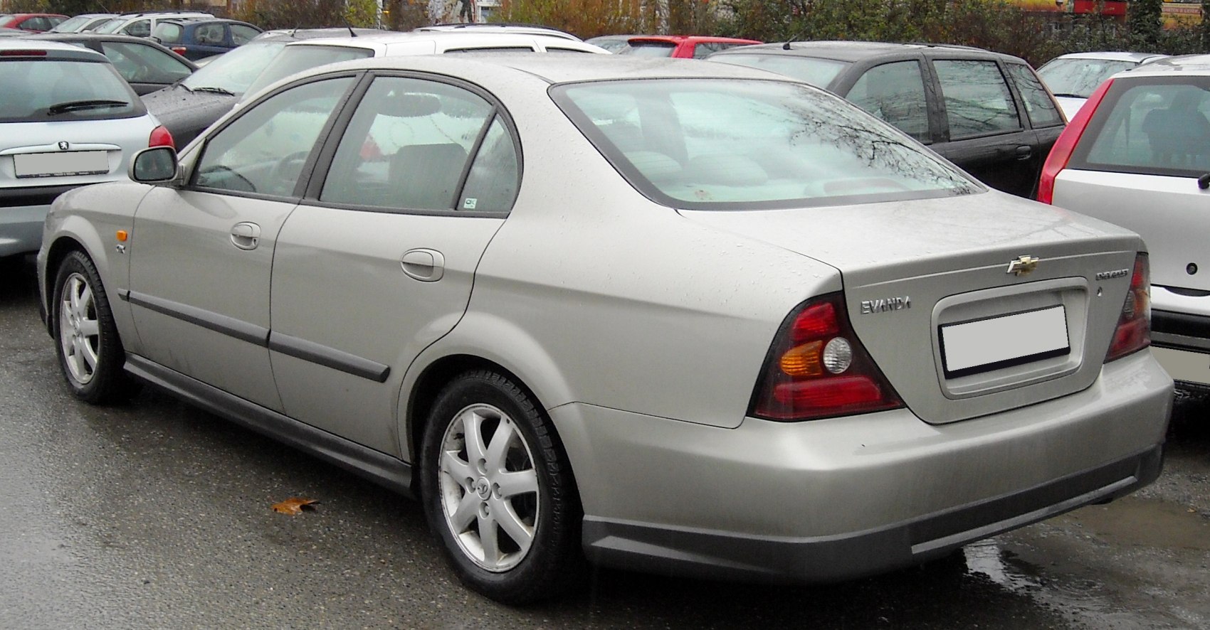 Rear and side view of a sedan with distinct tail lights and silver body.