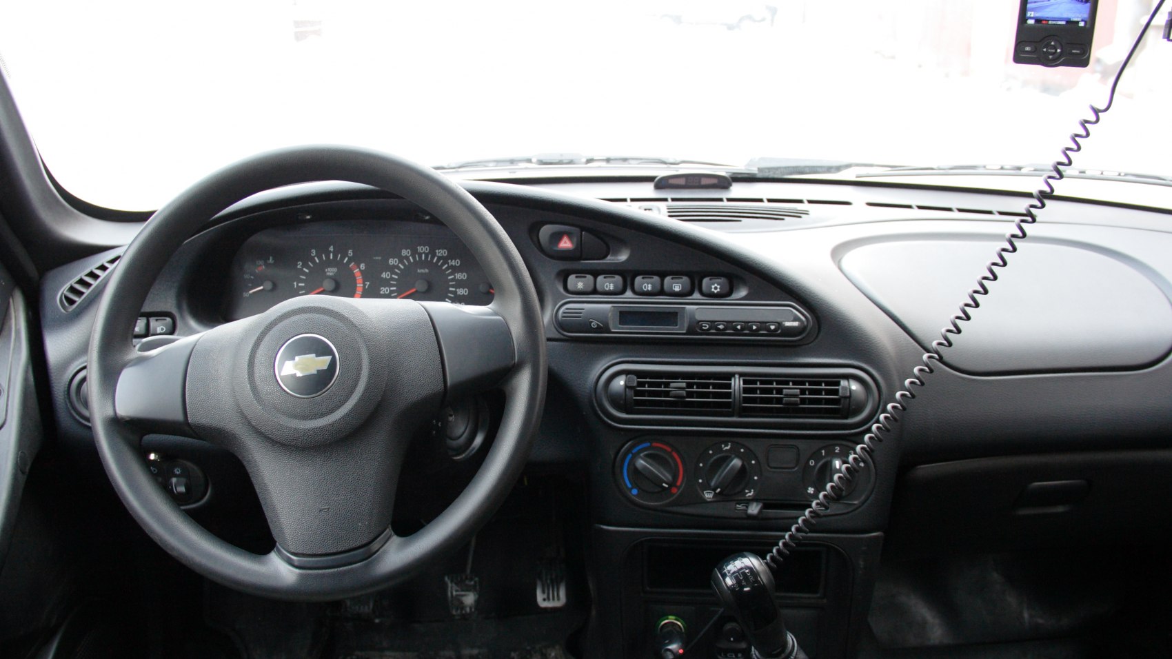 Car interior featuring dashboard, steering wheel, and center console controls.