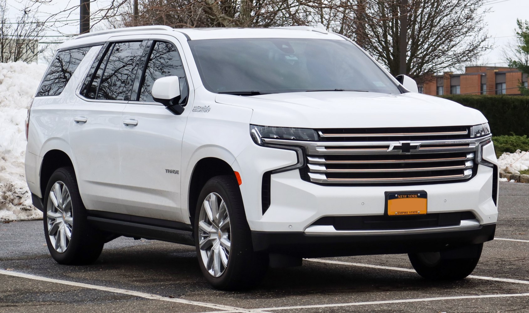 Front grille and LED headlights of large white SUV