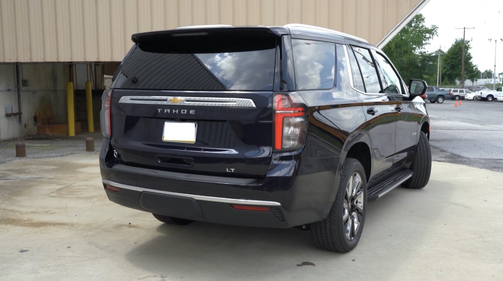 Rear and side view of a modern SUV with tinted windows and distinct taillights.