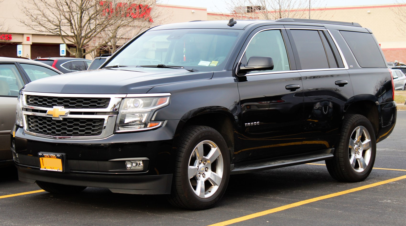 Black full-size SUV front side with grille and alloy wheels