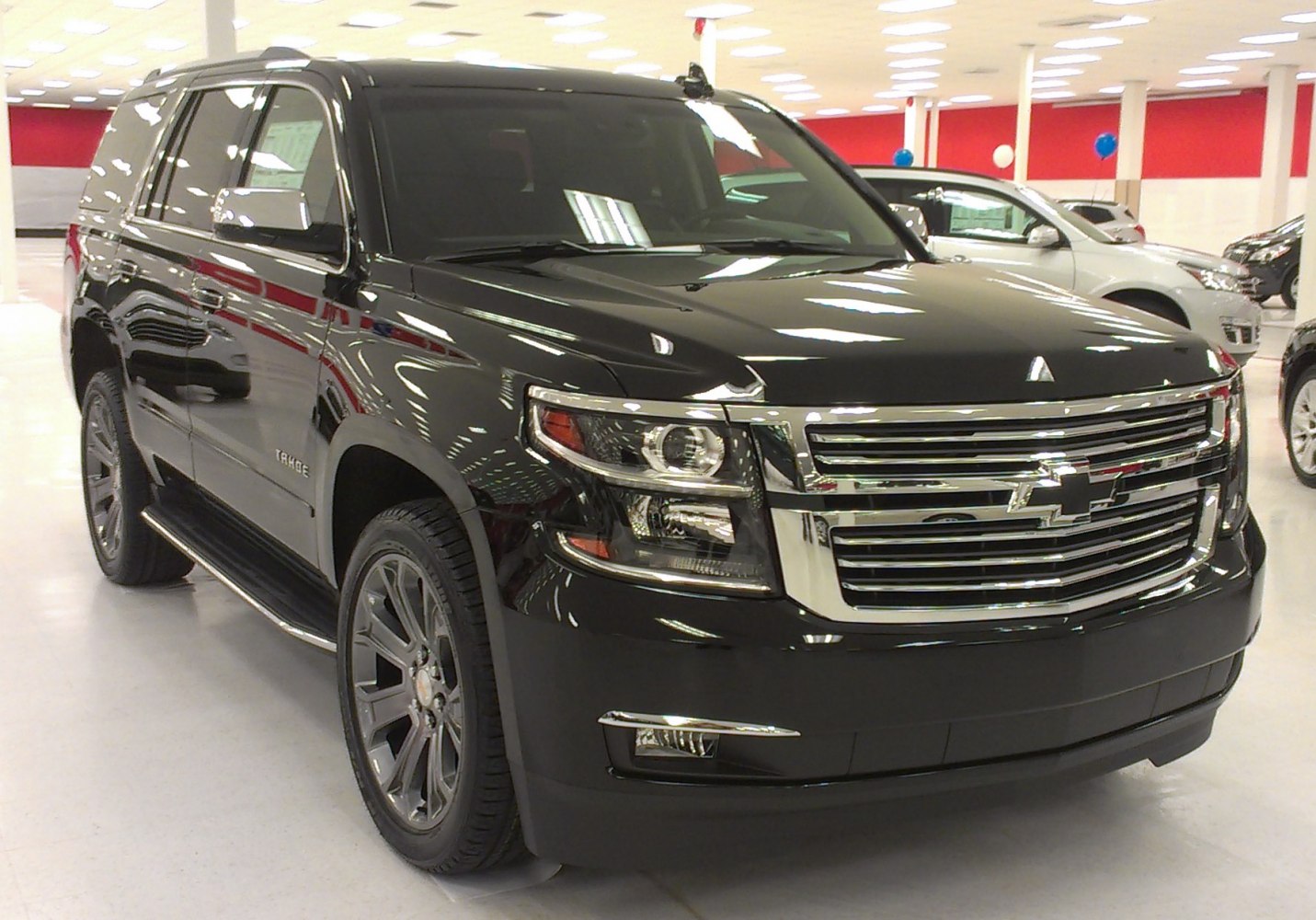 Black full-size SUV with chrome grille and alloy wheels