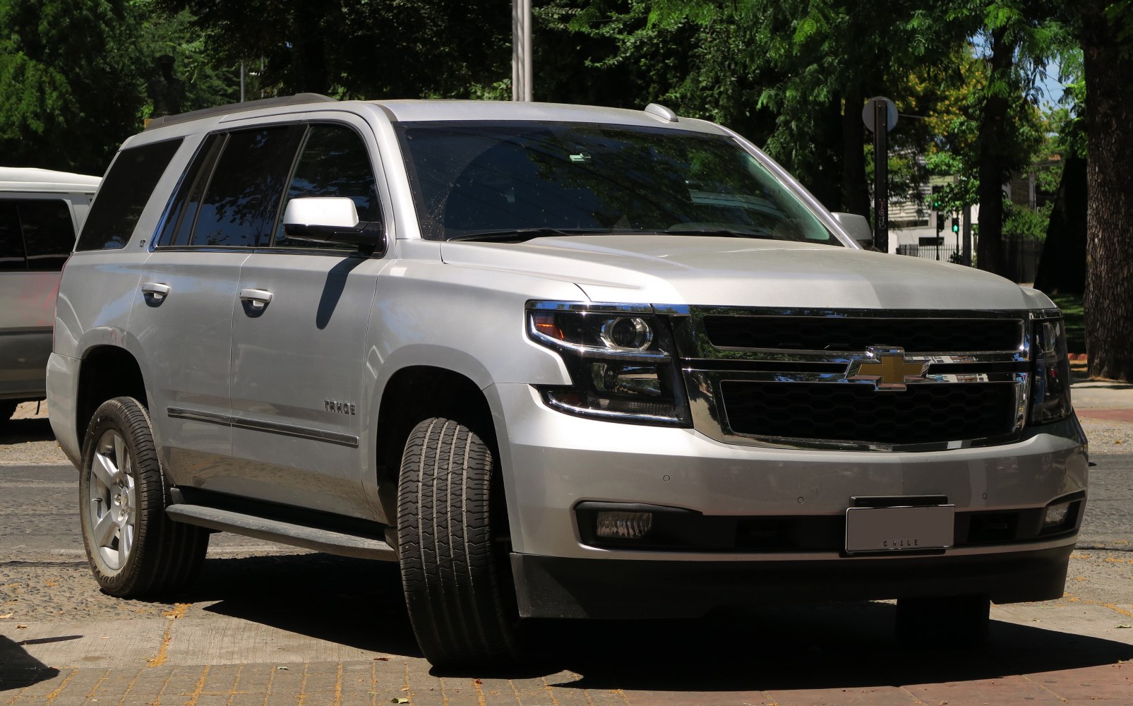 Front-side view with chrome grille and LED headlights