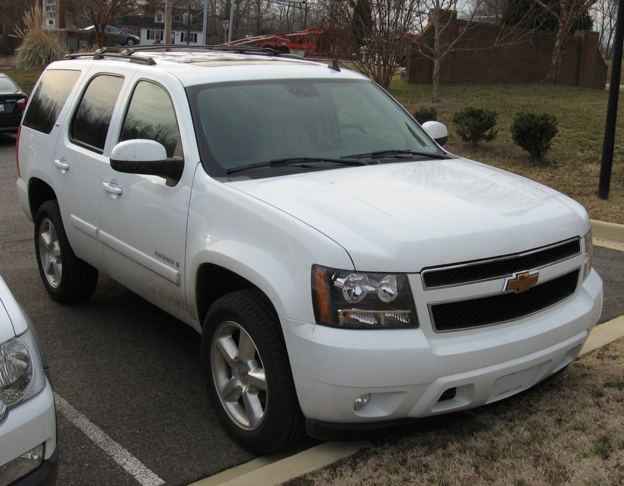 White SUV with tinted windows and alloy wheels parked sideways.