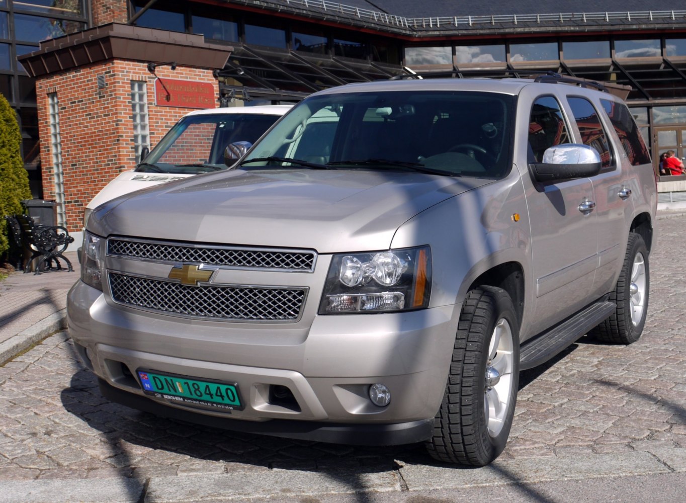 Silver SUV front view with bold grille and dual headlights.