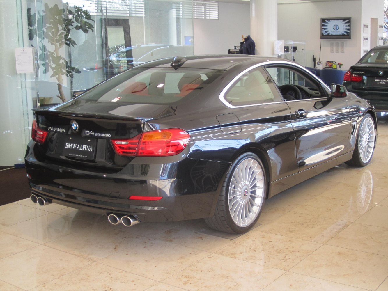 Rear side view with quad exhaust and multi-spoke alloy wheels