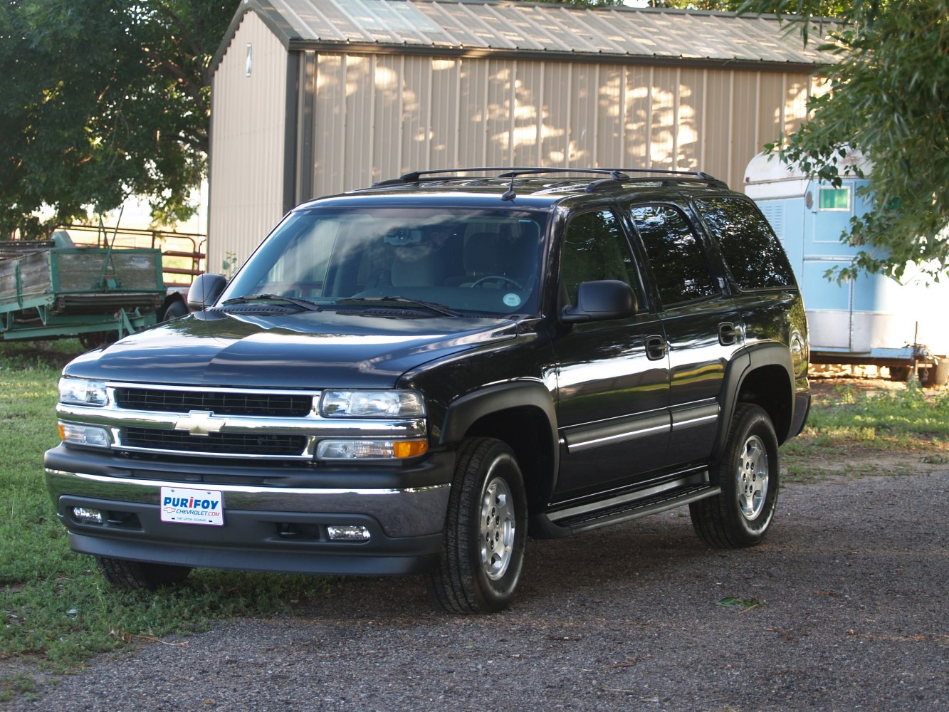 Black SUV front side with roof rack and running boards