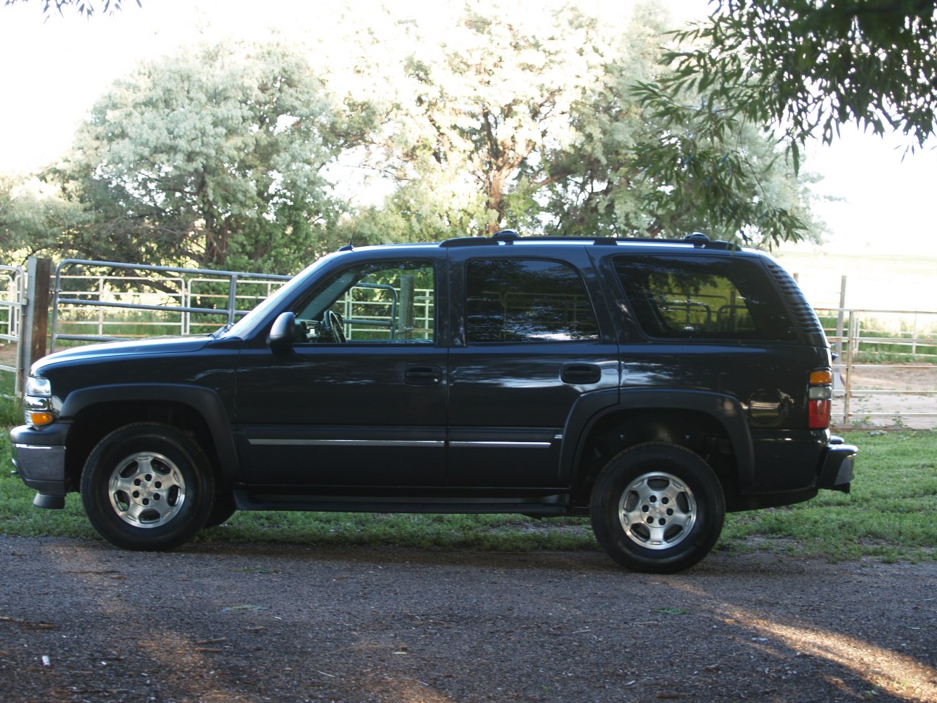 Side profile of an SUV with tinted windows and roof rails