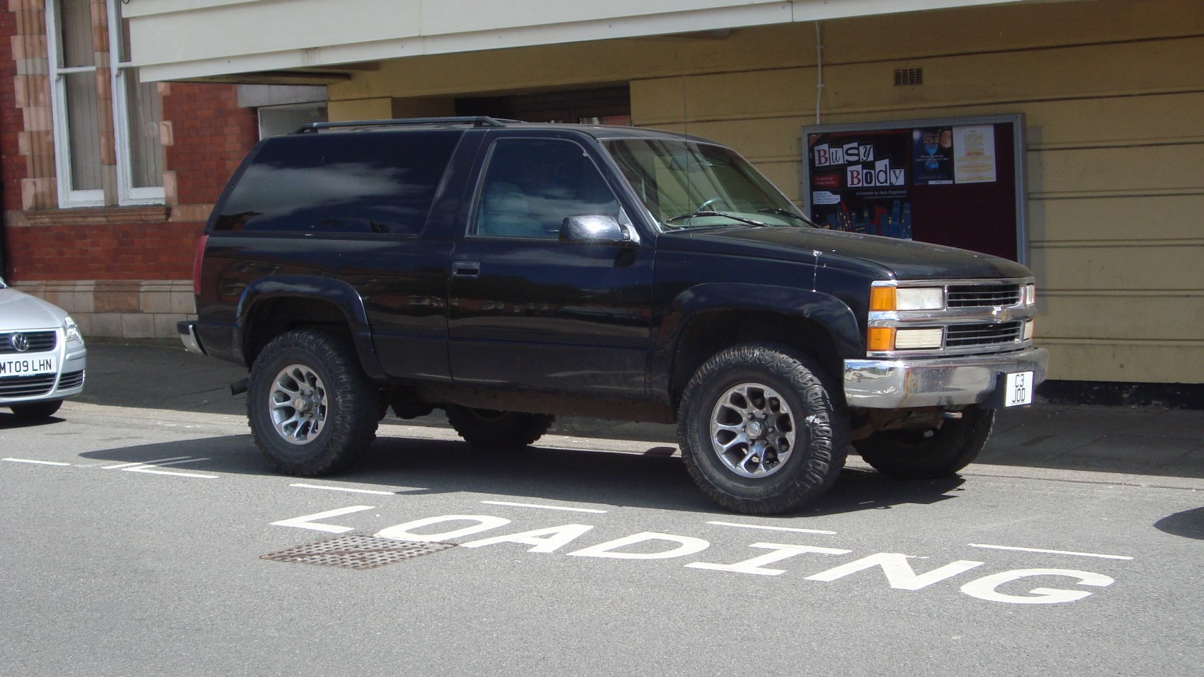 Black SUV with off-road tires and tinted windows