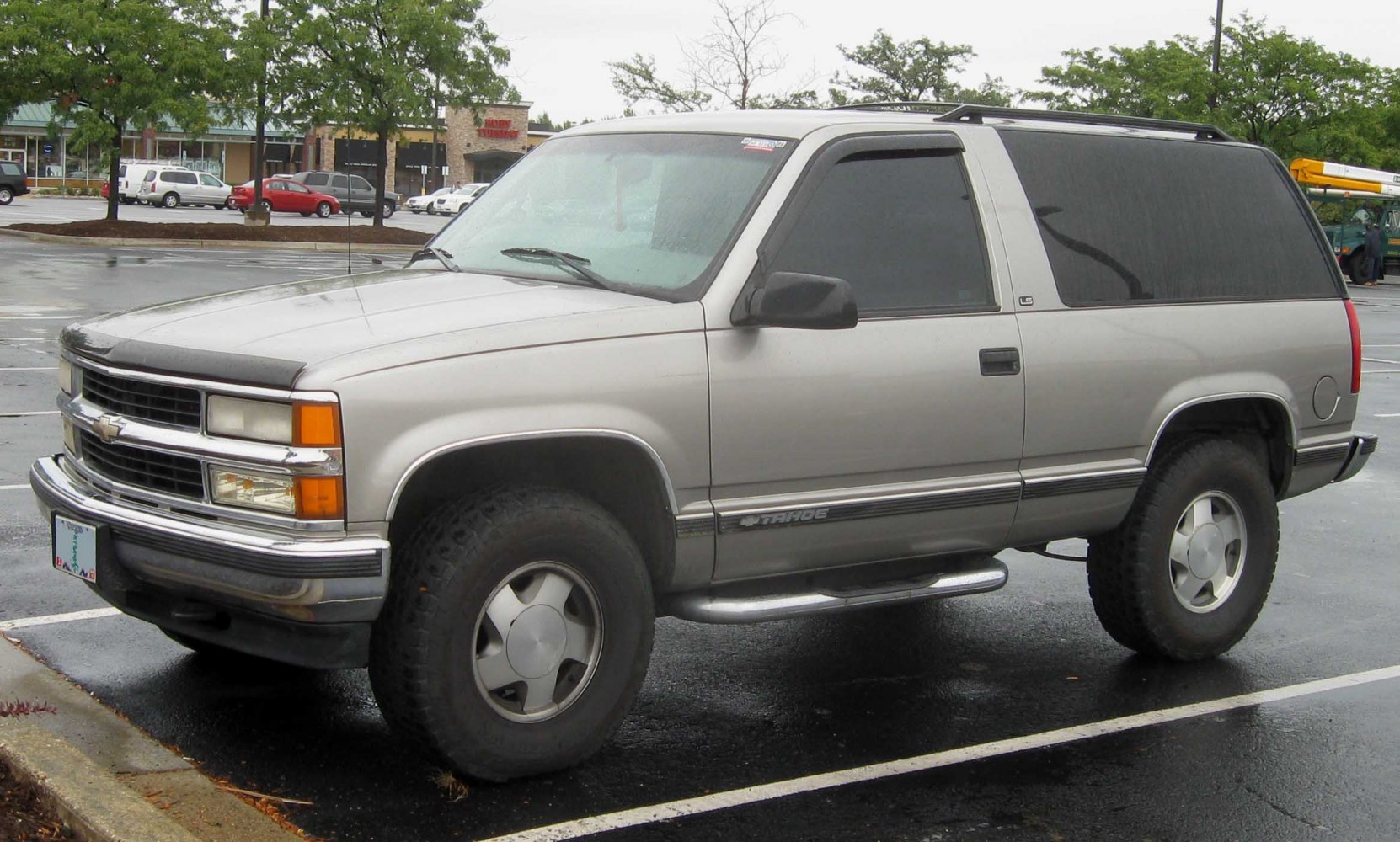 Front side profile of rugged SUV with large tires and two-door layout
