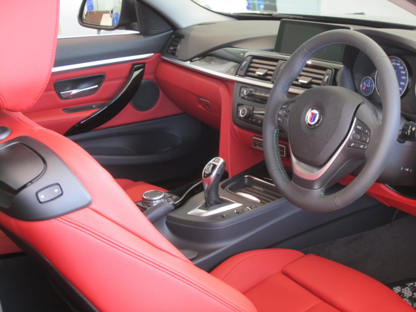 Red leather upholstery with steering wheel and gear shifter in center console