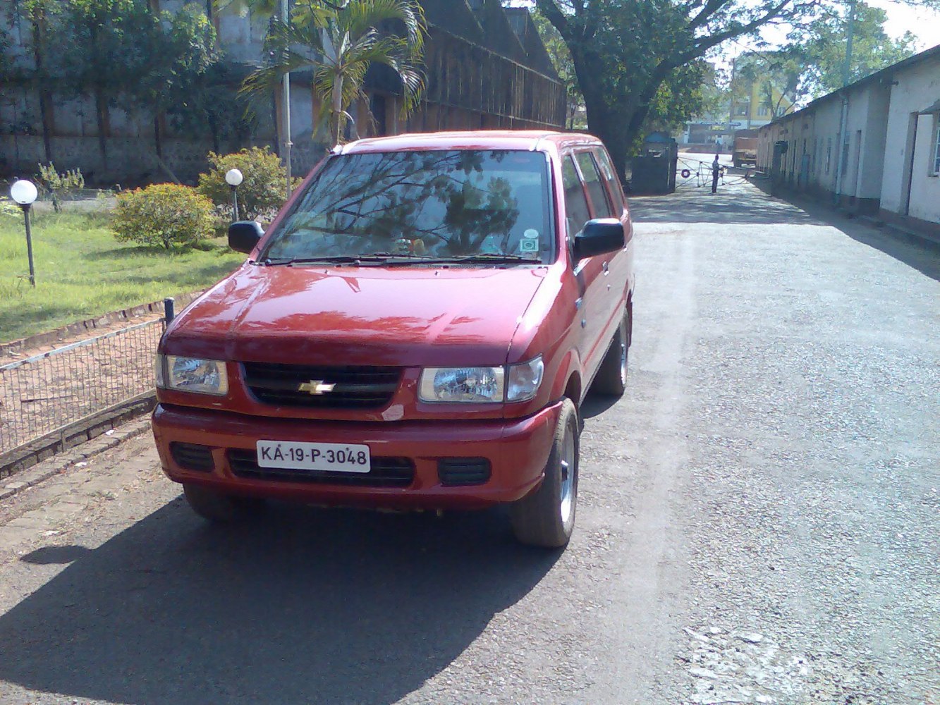 Front view showing grille, headlights, and red body of mid-size SUV