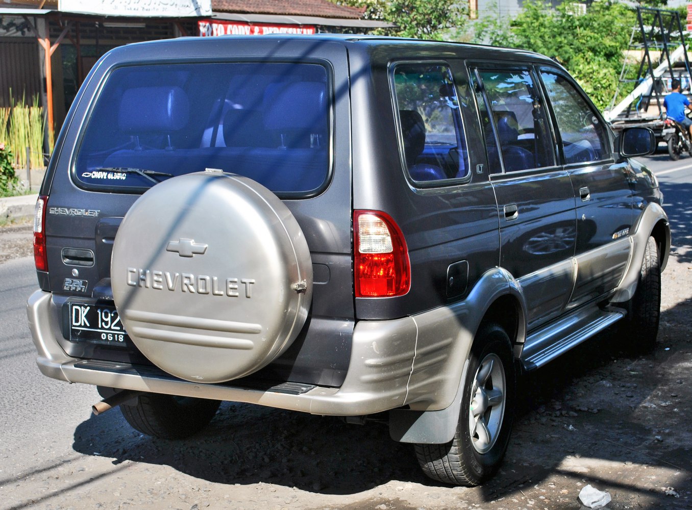 Rear view of SUV with spare wheel cover and tail light