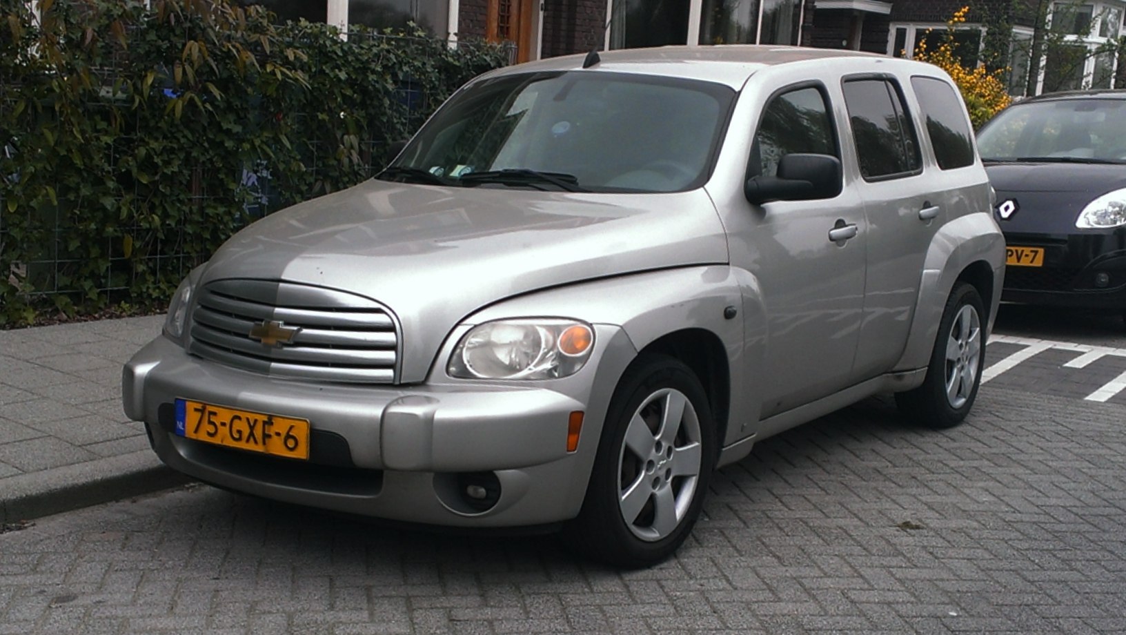 Retro-style compact SUV with rounded headlights and aluminum grille