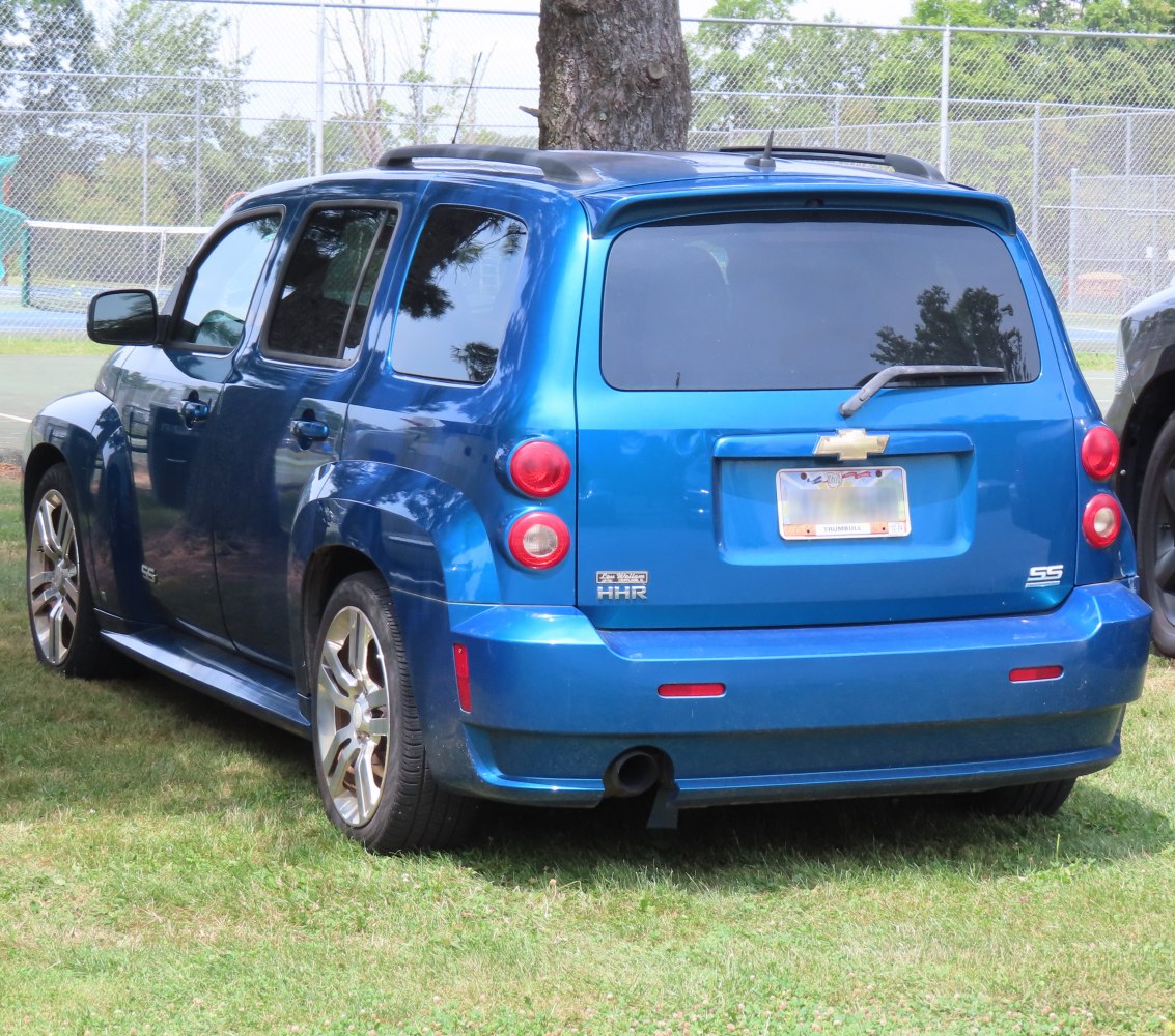 Rear side of blue compact wagon with distinctive taillights and rear wiper