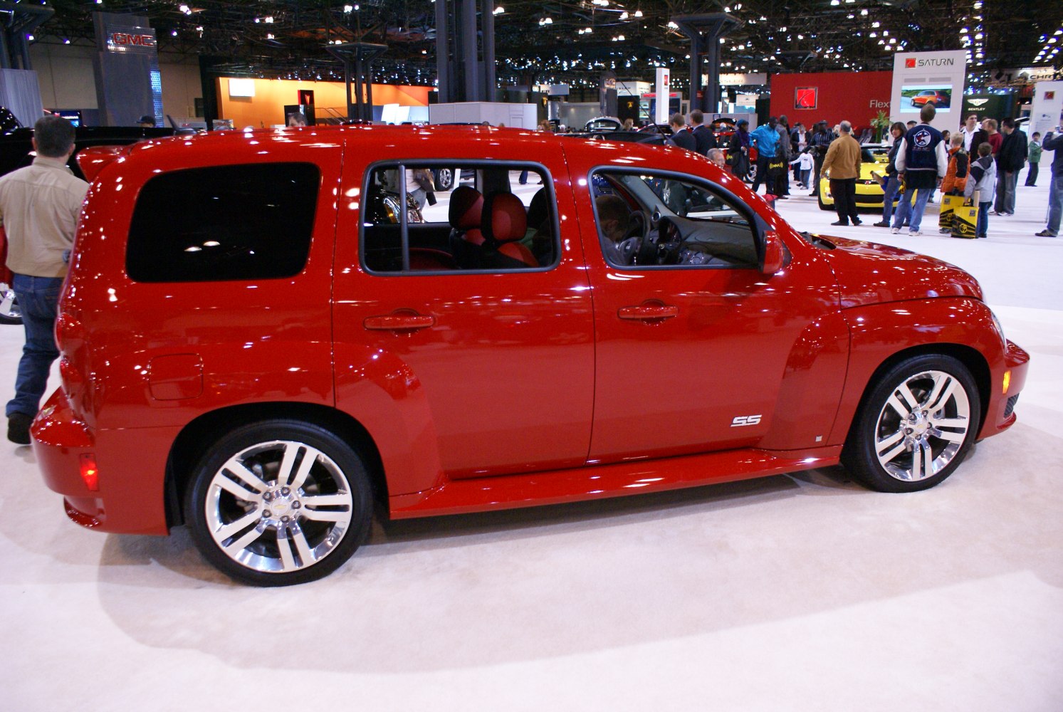 Side view of red compact SUV with chrome rims and sporty design