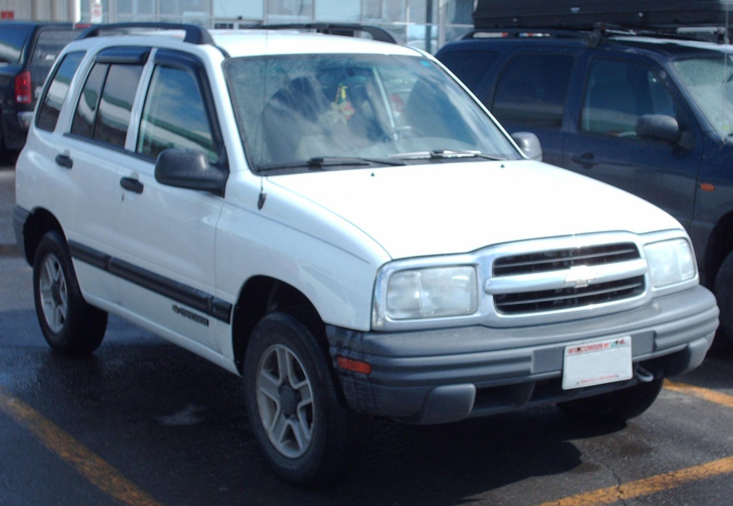 Front-side view of a 1990s compact SUV with prominent grille and bumper.