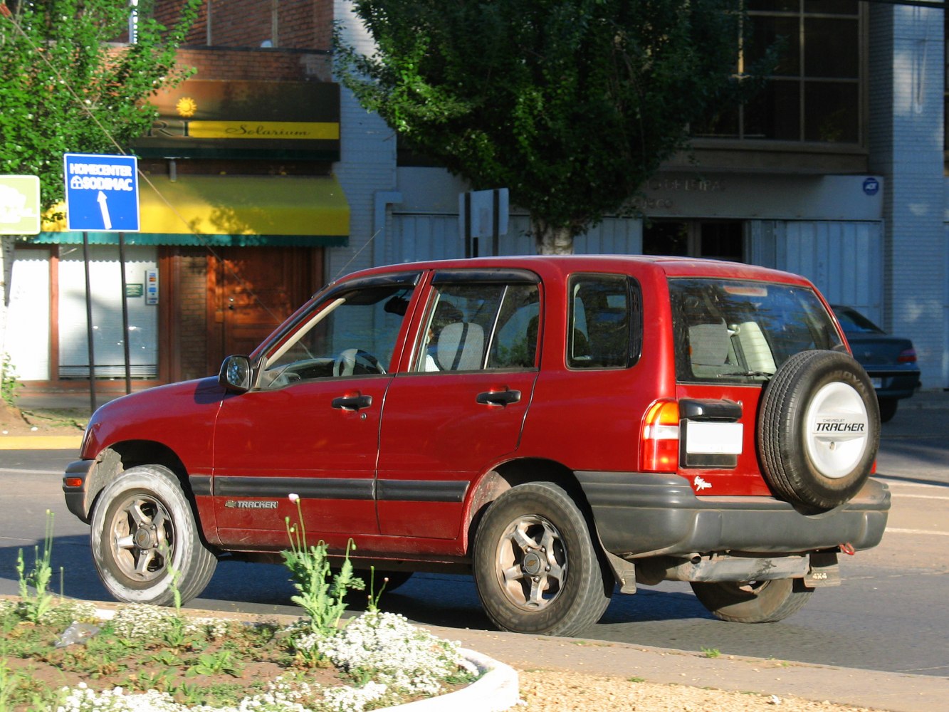 Red compact SUV with rear-mounted spare wheel and 5-door design
