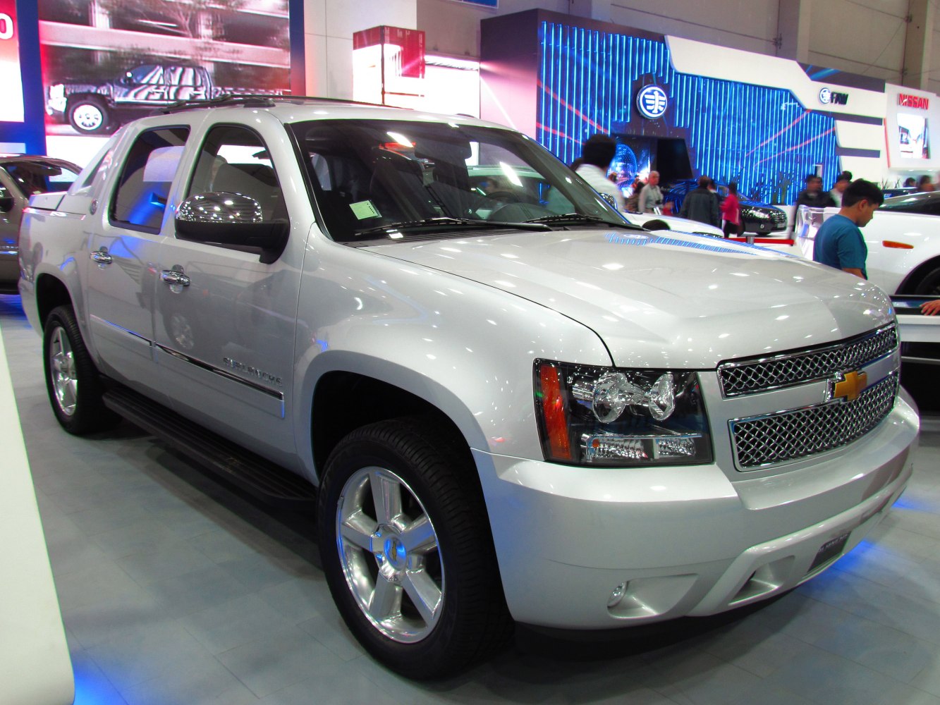 Silver pickup truck front side view with alloy wheels and running boards